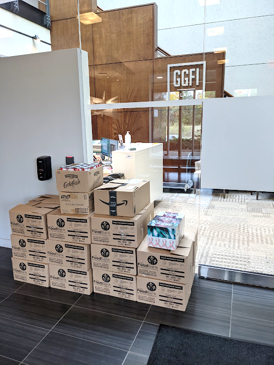 A pyramid of boxes filled with food beside the GGFI logo.
